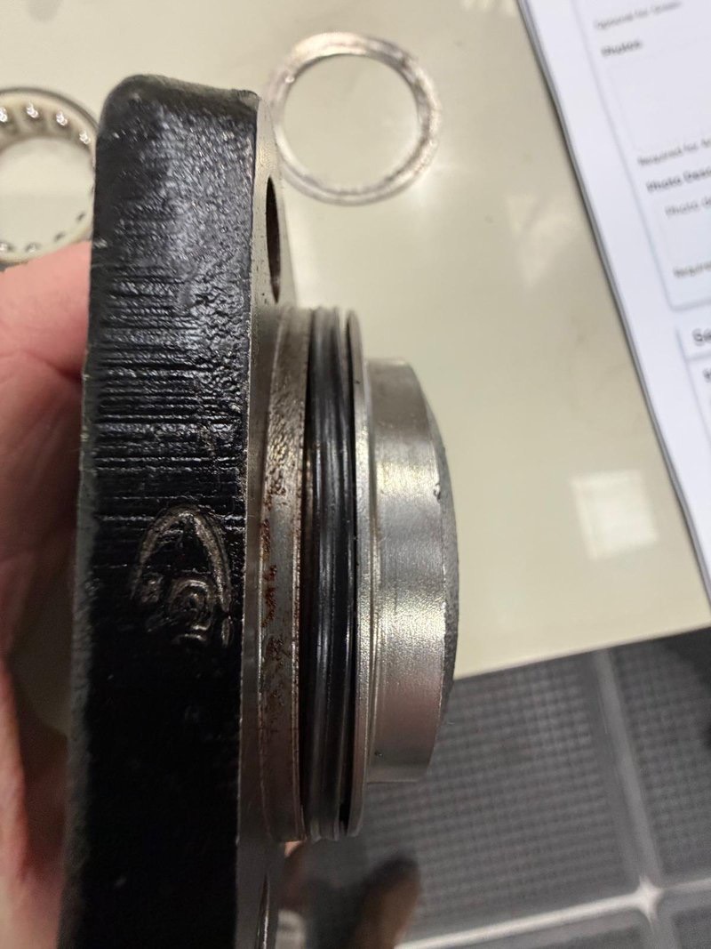 Cover plate removed from the steering box, showing a non-genuine seal fitted in the sealing groove